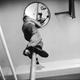 A black and white photo of someone sliding down a fire pole.